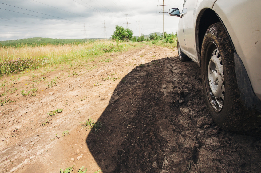 Dirt under the wheel of car