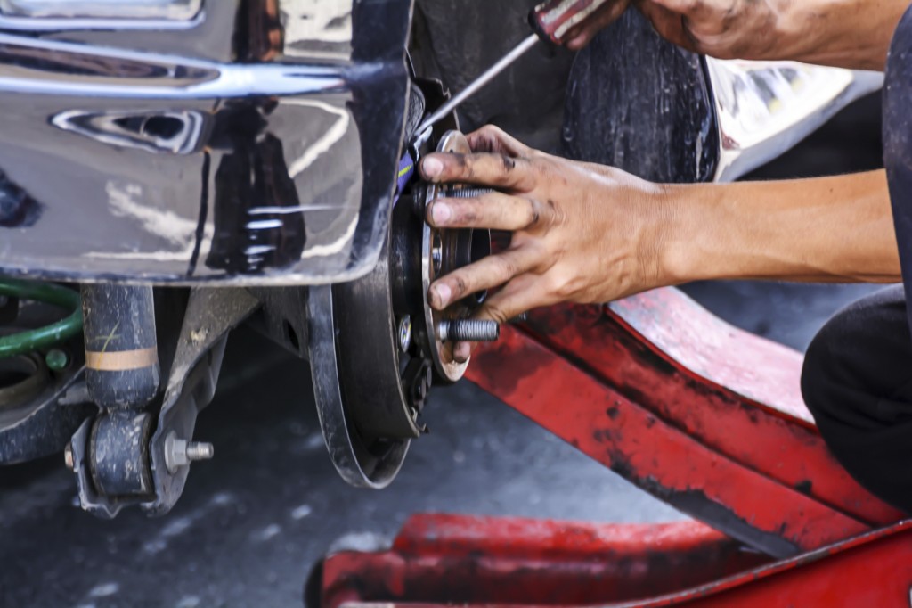 Mechanic replacing the brakes on a vehicle